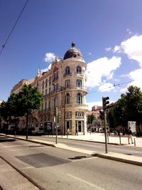 Road by building against sky