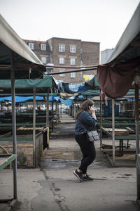 Full length rear view of woman walking in city