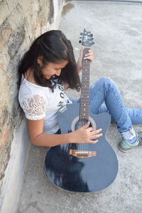 Young woman playing guitar