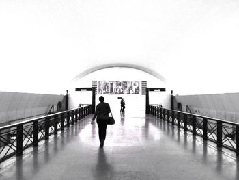 Low angle view of woman standing on railing