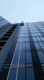 Low angle view of office building against clear sky