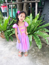 Portrait of cute girl with pink standing outdoors