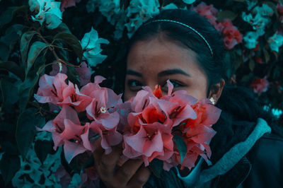 Close-up of young woman with flowers