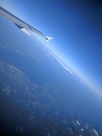 Low angle view of airplane flying over sea