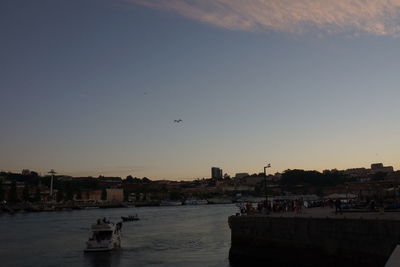 Boats in river with buildings in background