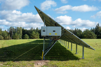 Huawei generator under solar panel on a green grass field