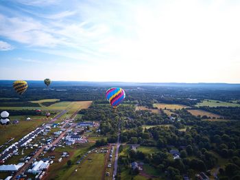High angle view of hot air balloon flying over landscape