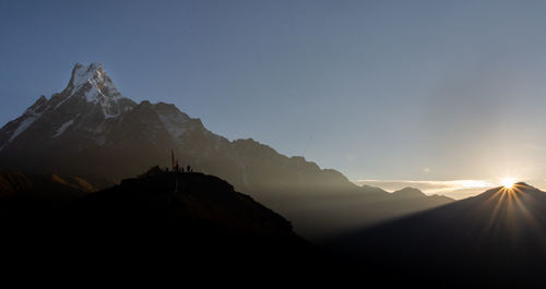 Scenic view of snowcapped mountains against sky at sunset