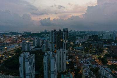 High angle view of illuminated buildings against sky during sunset