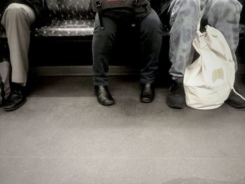 Low section of woman standing on tiled floor