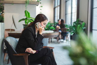 Business woman happy talking mobile phone in office spaces.