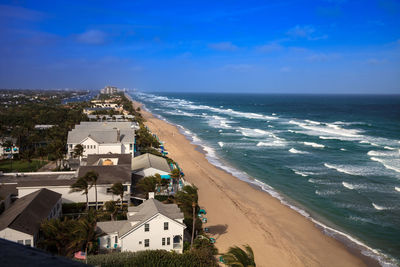 Scenic view of sea and buildings against sky