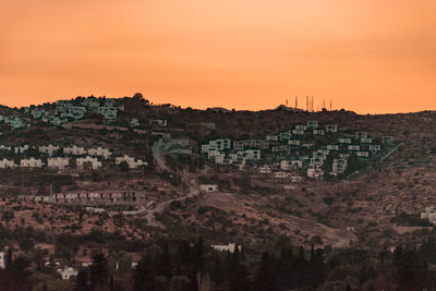 View of buildings in town at sunset