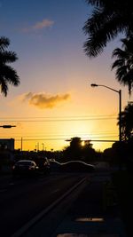 Cars on road at sunset