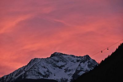 Scenic view of snowcapped mountains against sky during sunset