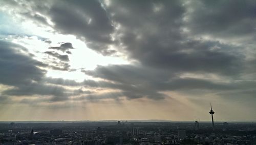 Cityscape against cloudy sky