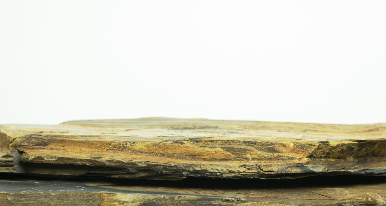 CLOSE-UP OF ROCKS AGAINST SKY