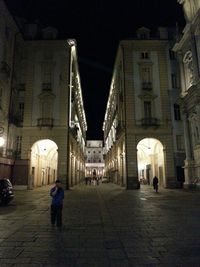 Full length of woman in illuminated city at night