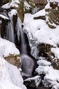 Scenic view of waterfall in forest during winter