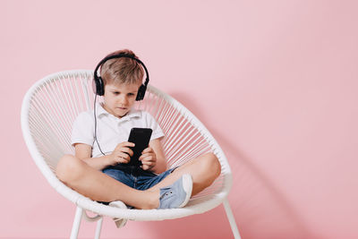 Full length of boy using mobile phone