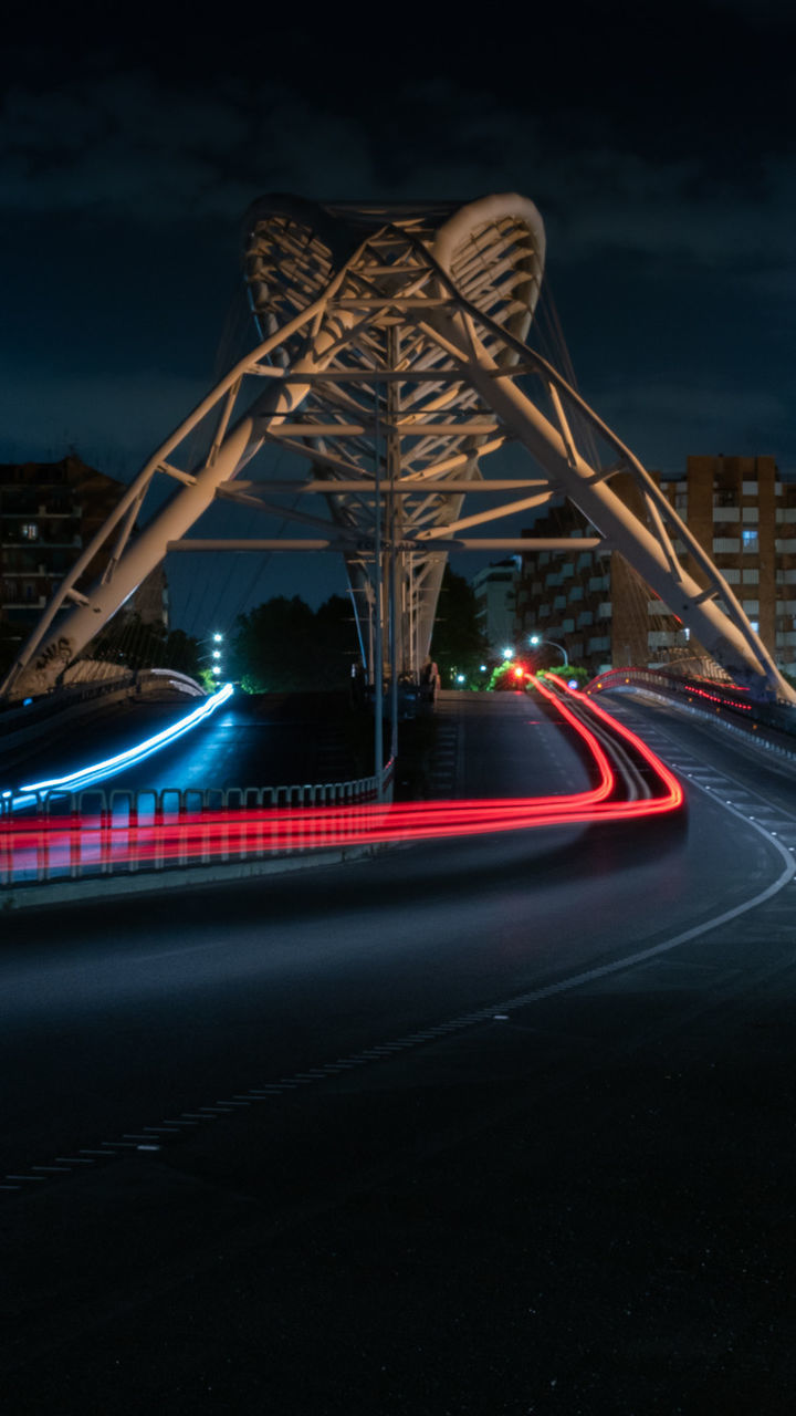 LIGHT TRAILS ON ROAD AGAINST SKY