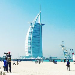 People in city against clear sky
