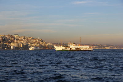 Scenic view of sea by buildings against sky