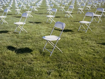 Empty chairs on field