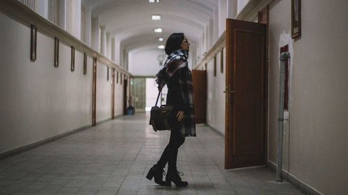 Full length of woman standing in building