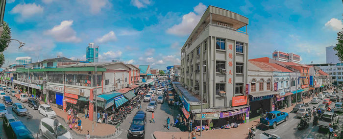 Panoramic view of city against cloudy sky