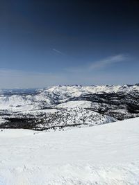 Scenic view of snow covered mountains against sky