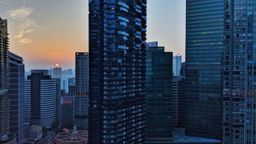 Modern buildings in city at sunset