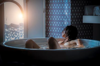 Woman relaxing in bathroom at home