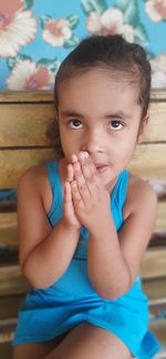 Portrait of cute girl sitting on bench