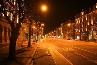 Illuminated city street at night