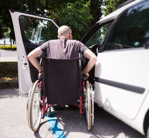 Rear view of man sitting in car