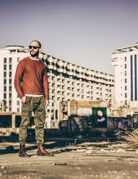 Full length of man standing by built structure against sky