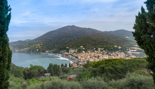 High angle view of townscape by mountain against sky