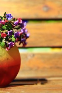Close-up of purple flower vase on table