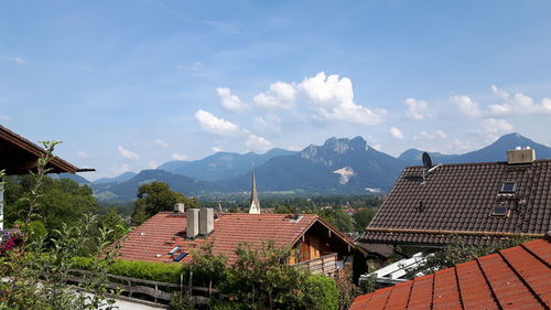 Buildings against sky with mountain range in background