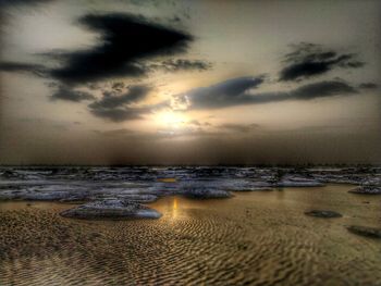 Scenic view of beach against sky during sunset