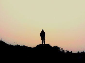 Silhouette of statue against sunset sky