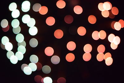 Defocused image of illuminated christmas tree against sky