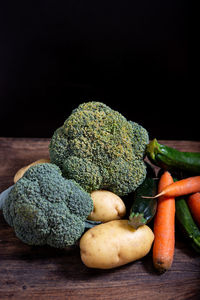 Close-up of vegetables on table against black background