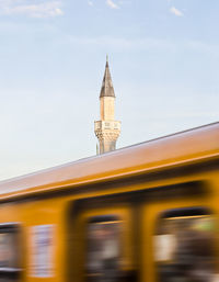 Blurred motion of vehicle against tower