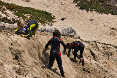 Rear view of people with children on land