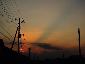 Silhouette of power lines at sunset