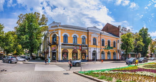 Street by building in city against sky