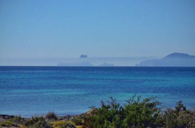 Scenic view of sea against clear blue sky