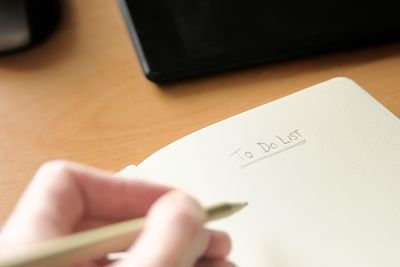 Close-up of person using laptop on table